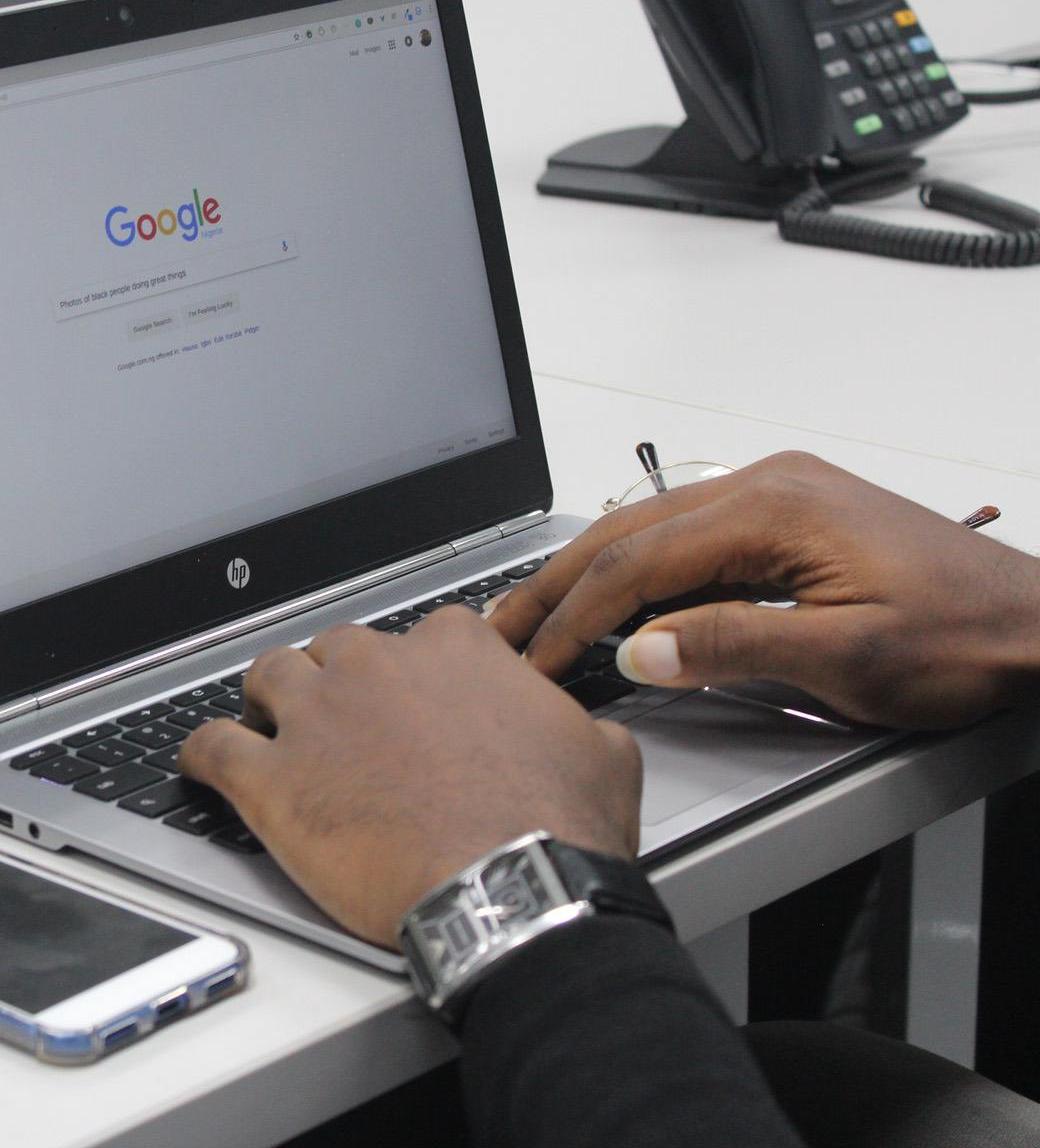 Man searching on google on a laptop