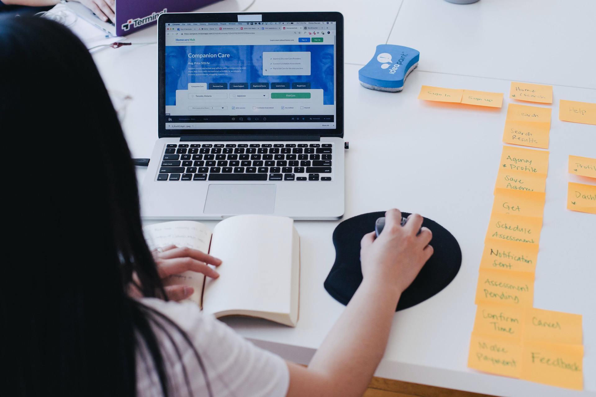 Woman with post-it notes and a laptop