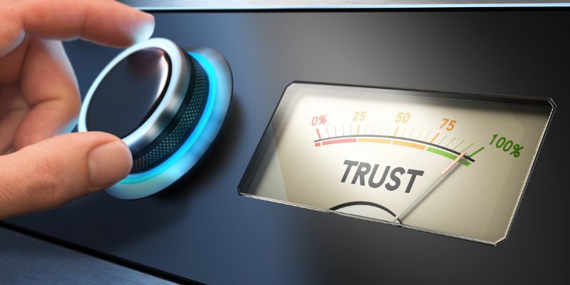 Visual representation of trust as a needle on a meter, with a hand rotating a dial to raise the level.