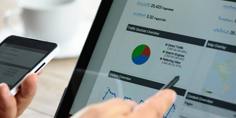 Close-up of tablet displaying Google Analytics traffic sources overview report data.