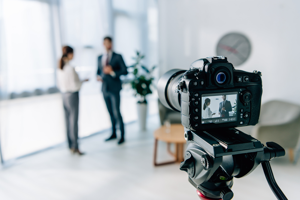 Camera filming two people.