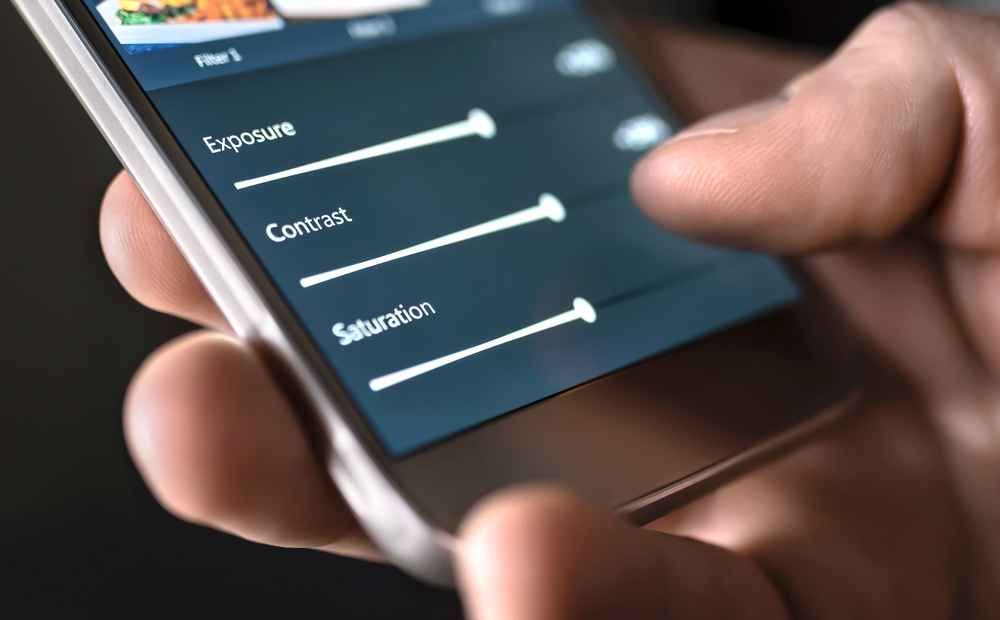Mobile phone screen showing someone editing a photo